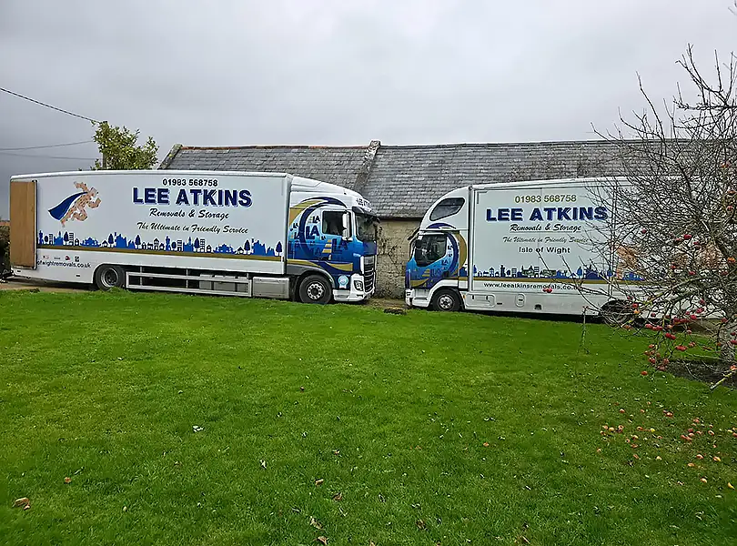 Two Lee Atkins removals lorries parked ready for a move on the Isle of Wight